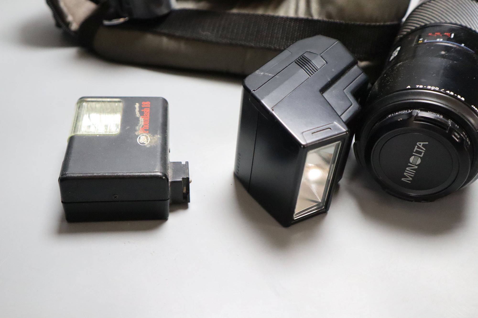 A Minolta 9000 SRL camera, a Minolta 75-300 zoom lens, with flash, together with a Sanwa Mycro miniature camera, with leather case